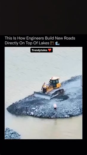 TrendyTales on Instagram: "This is how engineers create real, driveable roads in places where there was never land at all. The process starts by dumping massive volumes of rock and aggregate directly into the water, forming a stable base that displaces soft sediment and spreads weight evenly across the lakebed. Heavy machinery then compacts each layer, forcing water out and locking the stones together through friction and pressure. Once the base reaches the surface, engineers add graded layers,