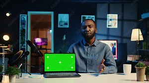 Tech internet star filming chroma key gaming laptop unboxing, giving reasons to purchase it. Influencer capturing video urging viewers to buy sponsoring partner mockup notebook