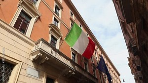 Italian flag moving slowly in wind. Europe union flag in back ground. Day time