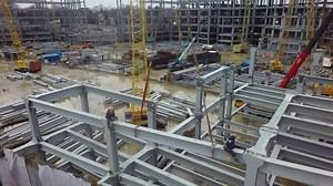 Steel structures of industrial buildings at construction site, aerial view