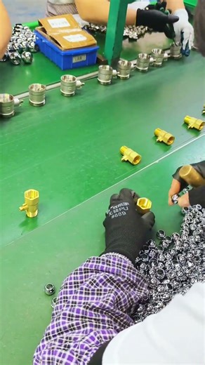 Factory Workers Assembling Small Brass Plumbing Fittings Manually
