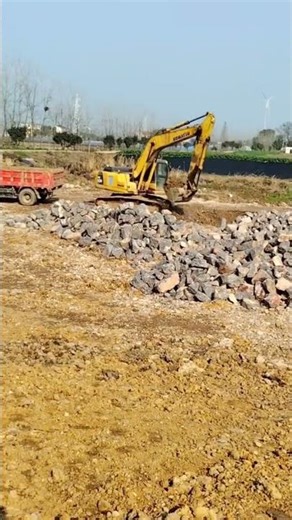 the process of moving excavated soil to a truck using an excavator