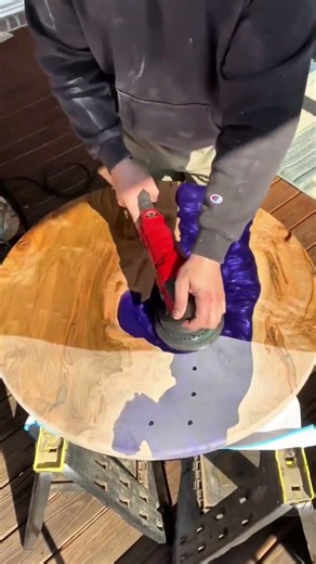 Polishing a Round Wood and Purple Resin Table with an Electric Orbital Sander on a Workbench