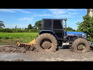 Come see the Ford 7840 plowing the garden, going through a little mud and a lot of water, and it ...