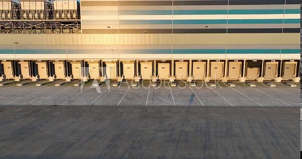 Truck loading and unloading deck platform at distribution center. Supply chain logistics and shipping.