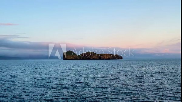 Remote Ellidaey island at Vestmannaeyjar in Iceland, view from moving vessel