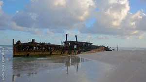 HD panning left to right motion with accompany beach sound, the abandoned SS Maheno shipwreck which washed ashore on the coastline of Fraser Island in 1935 by a cyclone and left to rust,QLD,Australia