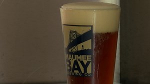 Maumee Bay Brewing Company's taps their winter brew for the summer