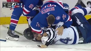Hope you have a better day than linesman Matt MacPherson (he’s in black and white, between Ryan Reaves and Patrick Maroon) | hockeyfights.com
