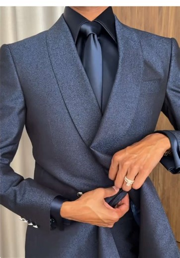 The Axis design in deep navy delivers sharp architecture through its sculpted double-breasted cut, strong shoulder line, and clean waist suppression. Creating a powerful, refined silhouette suited to weddings, formal events, and elevated evening dressing. Would you choose navy over black for your next formal look? #navysuit #doublebreastedsuit #weddingsuit #mensweartailoring #luxuryformalwear
