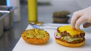 Burger restaurant menu cooking process. Chef hands preparing delicious hamburger with beef cutlet