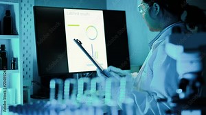 Lab assistant, a medical scientist, a chemistry researcher holds a glass tube through the blood sample, does a chemical experiment and examines a patient's blood sample. Medicine and research concept.