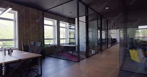 Modern startup centers composed of glass offices within a contemporary corporate environment, highlighting the sleek, innovative, and minimalist design aesthetics of a cutting-edge workspace