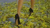 4K Close up of female legs in high heels . Rear back view of girl...