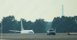 Security car at the airport. Background plane. Distant shot