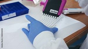 Scientist using a multichannel Pipette to collect samples in a chemistry lab