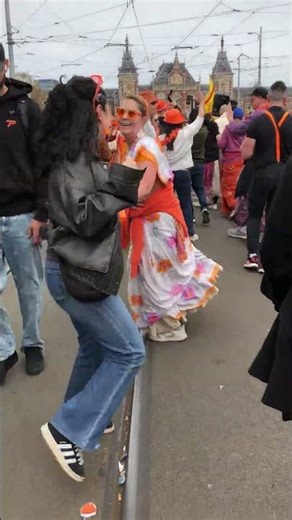 Devotee Woman Swings Onlookers at King’s Day in Amsterdam