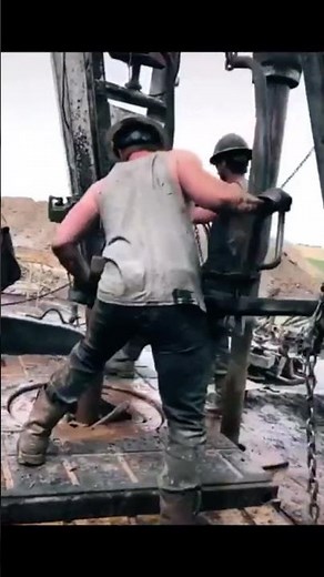 Oil rig workers throwing the chain