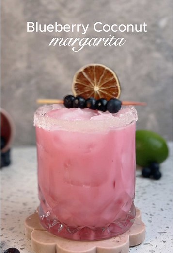 For todays recipe, we're making a Blueberry Coconut Margarita! In the past I hated tequila, but drinks like this one have helped me fall in love with it. I know how much everyone loves it so this one's for you guys! Drink Recipe: Blueberries 0.75 oz Lime Juice 1 oz Orange Liqueur 2 oz Tequila 1 oz Cream of Coconut Add blueberries and lime juice to a cocktail shaker and then muddle. Then, add orange liqueur, tequila and cream of coconut. Add ice and shake. Double strain over ice and garnish. Chee