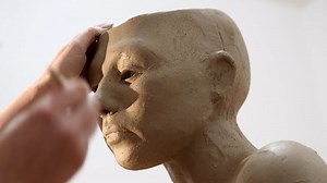 Sculptor Modelling Doing The Eyes Details Of Human Head Made Of Clay. Close Up