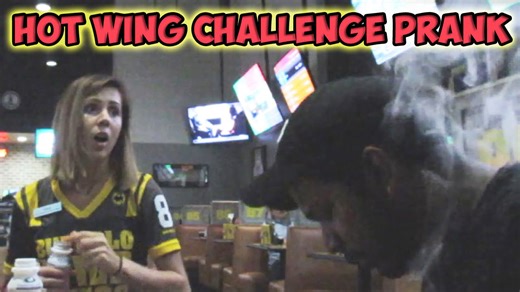 Contestants react as they attempt a spicy wing challenge