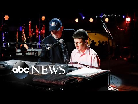 Billy Joel plays piano with blind fan before concert in New York City