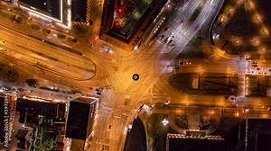 Time lapse zoom out cars speeding through illuminated intersection at night, Stuttgart