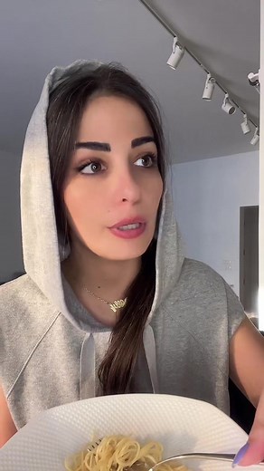 Enjoying Spaghetti in a Stylish Indoor Setting