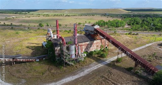 Abandoned industrial site of Mosaic phosphate plant in Florida. Historic mining factory complex overtaken by nature.