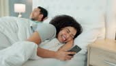 Divorce, cheating and woman texting on a phone while in bed with her...