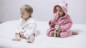 Two Kids in Bathrobes on a White Background with Wet Hair after Taking a Bath. Boy and Girl after Shower on a White Bed Stock Footage - Video of fright, flip: 173656266