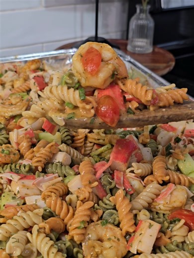 Seafood Pasta Salad Ingredients for a large pan: 4 boxes tricolor rotini 1 bag colossal shrimp 2 bags large shrimp 3 packs imitation or lump crab meat 1 pack cherry tomatoes 2 cucumbers 2 Green onions 1 36oz olive garden Italian dressing 1 24 oz Italian dressing Seasonings: complete, old bay, kinders hickory brown sugar, and garlic powder