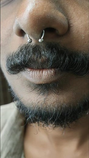 septum piercing for men done professionally using piercing needles