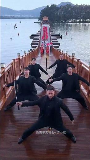 Yuan Zhiping and his team performs the Jingpo sword dance in the rain