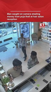 2.4M views · 16K reactions | A shocking CCTV video from a hair salon has gone viral, showing two men pulling off a theft in broad daylight. While one distracted the receptionist, the other slipped cash from a puja thali kept on the counter. A security guard stood nearby, unaware of the act. The clip has left netizens furious online. [CCTV, Viral Video, Puja Thali] #ETTrendingNow | ET NOW | Facebook
