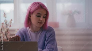 Young woman small business owner working with client database on laptop, app