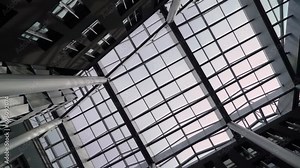 Atrium glass roof of yard inside building - business center, hotel or trade shopping. High quality FullHD footage