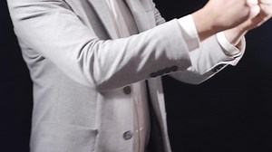 Businessman being arrested, handcuffed. The man in the suit is handcuffed by the police.