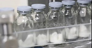 dry powder injection vaccine manufacturing line glass vial bottle on a conveyor in a Pharma production factory injections in small ampoule vials factory process latest machinery Stock Video