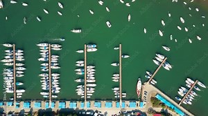 Aerial top down view of parked boats, motorboats and sailboats at marina piers