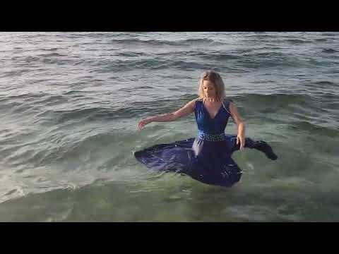 Bella goes swimming in the sea in her blue dress Trailer