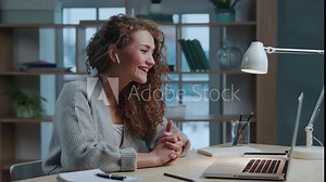 Happy Woman Video Calling and Talking on Web Cam of Laptop Pc at Home. Pretty Female Sits at Table and Uses Webcamera Application for Zoom Chat on Notebook. Computer Tech with Display or Online Device