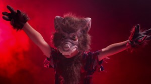 Studio Shot Of Child Dressed Up In Werewolf Monster Costume Trick Or Treating At Halloween With Red Smoke Background Lighting Scaring People | Free Stock Video Footage