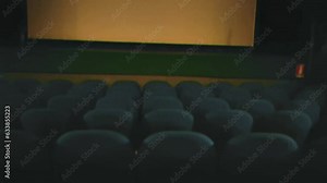 Recreated fake handheld VHS shot of an empty theater (cinema), capturing the nostalgia of a bygone era, where time seems to stand still amidst the faded grandeur of velvet seats.