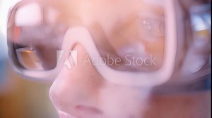 A closeup of a person with autism using VR technology to practice appropriate social media interactions such as commenting and responding to posts in a virtual platform.