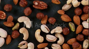 Super slow motion of moving mix nuts. Filmed on high speed cinematic camera at 1000 fps.