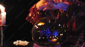 Hands of a fortune teller in a magical read the future in a crystal ball. Overall plan