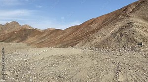 desert peruvian road with rocks view from the window, fade out in wall of mountains