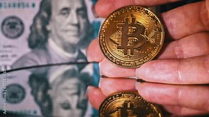 Bitcoin coin on a background of dollars. Bitcoin coin, digital gold next to the hands of an expert trader counting profitable banknotes in the form of dollar cash. Cryptocurrency