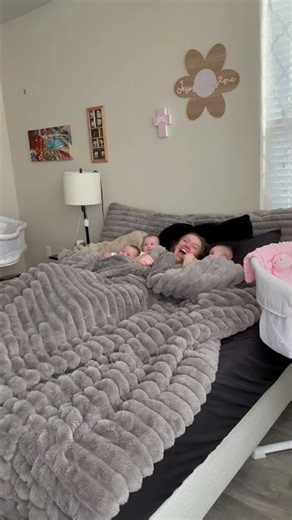 Mom and Her Babies Share Contagious Giggles in Bed